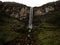 Tiny hiker in yellow jacket at Catarata del Gocta waterfall cataract cascade in Amazonas near Chachapoyas in Peru andes