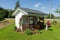 A tiny house surrounded by flowers