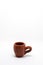 Tiny iconic brown hot chocolate mug isolated on a white background