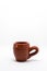 Tiny iconic brown hot chocolate mug isolated on a white background