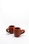 Tiny iconic brown hot chocolate mug isolated on a white background