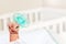 Tiny infant boy hand fist lift up holding pacifier