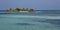 Tiny islet in turquoise waters of Maldives