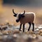 tiny knitted wildebeest toy in the grass