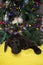 Tiny labrador puppy sleeping near a Christmas tree