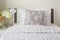 Tiny lavender pattern style bedding in bedroom with white orchid