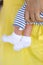 Tiny legs of newborn baby in white sokcs