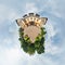 Tiny little planet with trees near beautiful building, white clouds and soft blue sky of amusement park. 360 degrees viewing angel