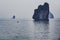 Tiny little Vietnamese fisherboat on sea in Ha Long Bay on misty day