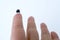 Tiny microchip on finger of female hand on white background, research, development of microelectronics and processors, concept