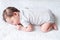 Tiny newborn baby sleeping on knitted blanket