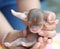 Tiny newborn brown chihuahua being held in hand