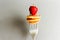 Tiny pancake cereal mini pancakes on fork with strawberries on grey background