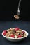 Tiny pancake cereal - trendy quarantine food. Mini pancakes in bowl with fresh raspberries and coconut flakes and fork with one