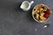 tiny pancakes with strawberries and milk, pancake porridge in a bowl on a gray concrete background