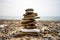 Tiny Stone Cairn on Rocky Beach Shore