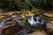 Tiny waterfall closeup in a bubbling creek.