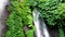 Tiny waterfall in tropical forest. Indonesia, Bali, Drone aerial, slow motion.