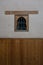 Tiny wooden closed window on an ancient building wall in Marrakesh, Morocco