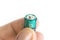 Tip of the fingers holds alkaline battery.