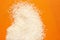 Tip view of raw basmati rice on orange  background