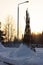 Tipi posts stuck in the thick snow in the middle of winter surrounded by lush green pines