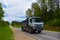 Tipper Dump Truck transported sand from the quarry on driving along highway. Modern Heavy Duty Dump Truck with unloads goods by