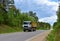 Tipper Dump Truck transported sand from the quarry on driving along highway. Modern Heavy Duty Dump Truck with unloads goods by