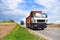 Tipper Dump Truck transported sand from the quarry on driving along highway. Modern Heavy Duty Dump Truck with unloads goods by