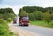 Tipper Dump Truck transported sand from the quarry on driving along highway. Modern Heavy Duty Dump Truck with unloads goods by