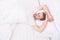 Tips promoting healthful sleep habits. Handsome man relaxing in bed. Establish regular nightly sleep pattern. Practice