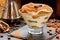 Tiramisu cake in glass, classic Italian dessert from cookies savoiardi, mascarpone cream and cocoa
