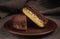 Tiramisu cake lies on a clay plate