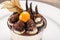 Tiramisu dessert cake with ground cherry closeup on white plate