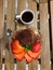 Tiramisu garnished strawberries and mint in martini glass top view. Cup of coffee. Wooden table