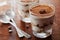 Tiramisu in glass on vintage table, traditional coffee flavored Italian dessert