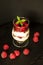 Tiramisu with raspberry in glasses on grey background. Three portion. Italian dessert.
