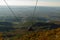 TIRANA, ALBANIA: Panoramic aerial view to Tirana from top of Dajti Mountain, National Park. Visible cable car cabins.