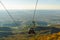 TIRANA, ALBANIA: Panoramic aerial view to Tirana from top of Dajti Mountain, National Park. Visible cable car cabins.