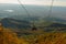 TIRANA, ALBANIA: Panoramic aerial view to Tirana from top of Dajti Mountain, National Park. Visible cable car cabins.