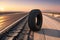 Tire Abandoned on a Desolate Highway - Positioned Upright with Its Tread Facing the Viewer, Distant Horizon