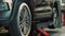 Tire. Car service. In the auto service, the car is on a lift, providing access to the underside of the vehicle for