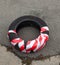 Tire cover wrapped in red and white safety strip