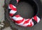 Tire cover wrapped in red and white safety strip