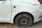 Tire leak, close up wheel of old white vintage car. Car wheel flat tire on the road. Deflated the tyre of an old car next to a