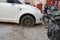 Tire leak, close up wheel of old white vintage car. Car wheel flat tire on the road. Deflated the tyre of an old car next to a