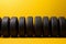 Tire lineup Row of tires presented on a vibrant yellow background