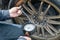 Tire Pressure Gauge and technician hands checking tyre pressure