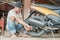 Tire repairman sits while removing the inner tires of the motorbike