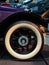 Tire and rim of a vintage car. Shiny and polished wheel of an old car. Exhibition cars